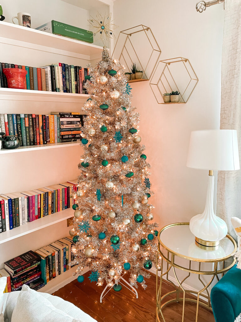 Gold Christmas tree with silver, blue, and green ornaments in the corner of my reading room