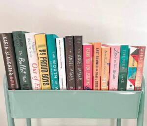 Bookstagram content ideas #20: bookish accessories. A teal book cart filled with books.