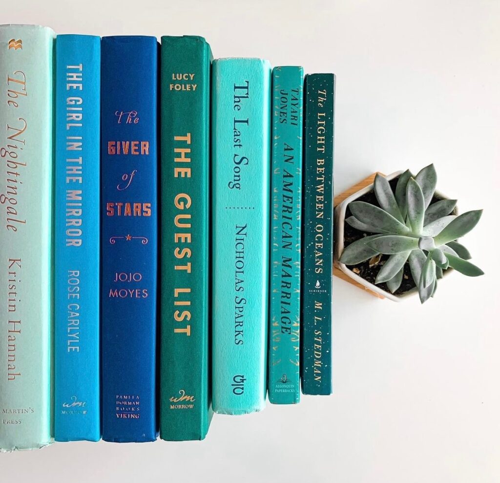 bookstagram content ideas -book stack challenges. A stack of blue spined books